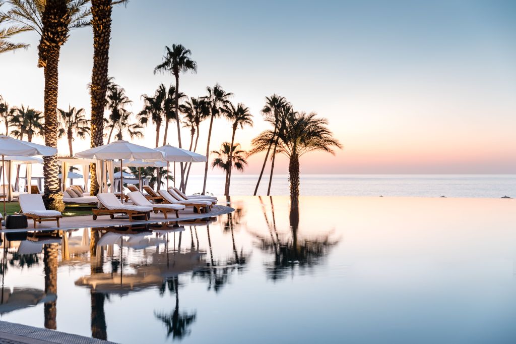 Hilton Los Cabos - Pool - lounge chairs and palm trees reflect in pool