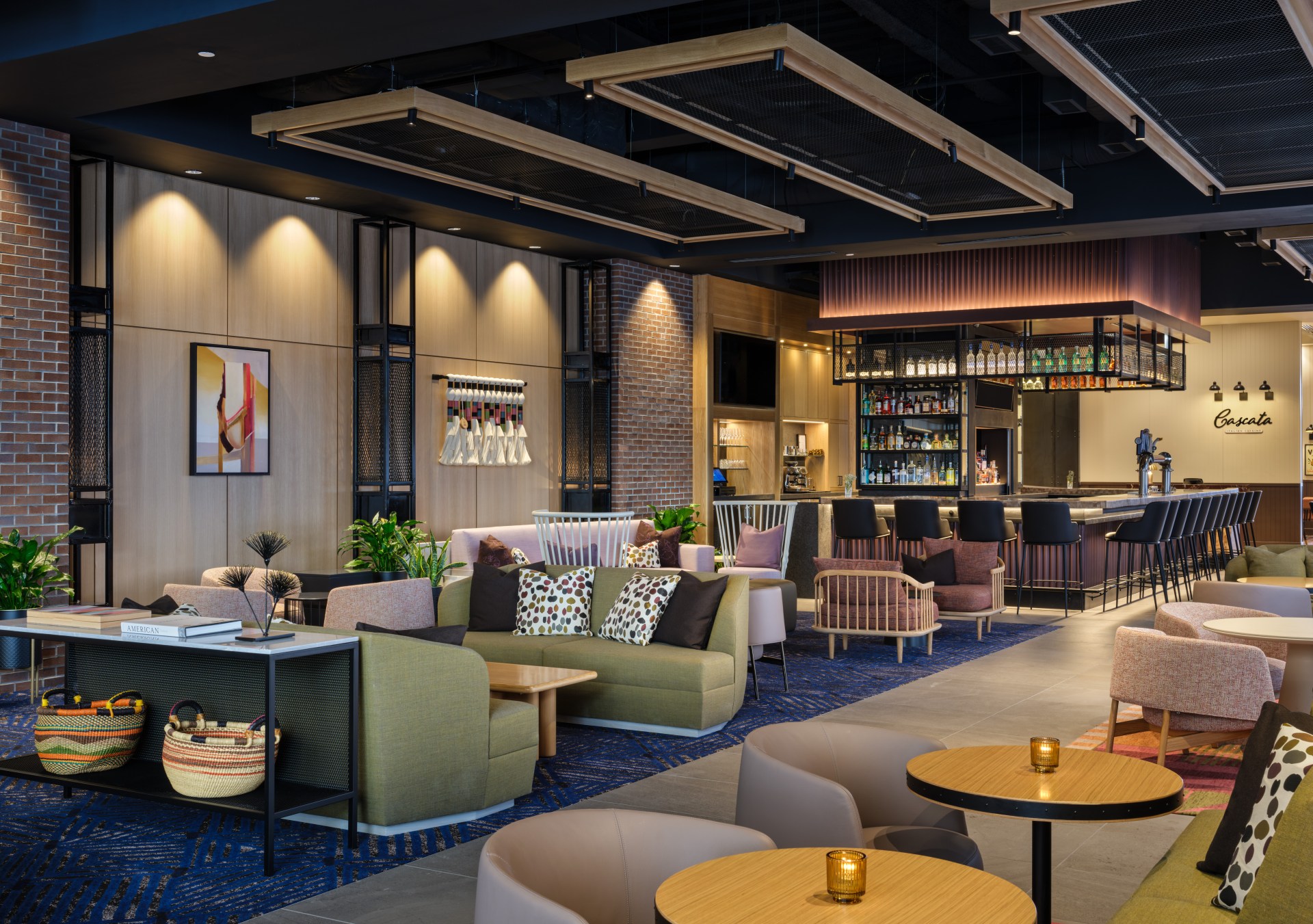 Canopy by Hilton Sioux Falls Downtown - Restaurant, variety of colorful seating, artwork and accents, and bar area