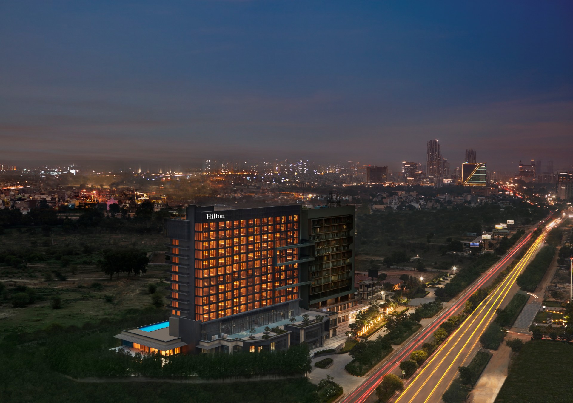 Hilton Gurugram Baani City Centre - Hotel Facade aerial view at night