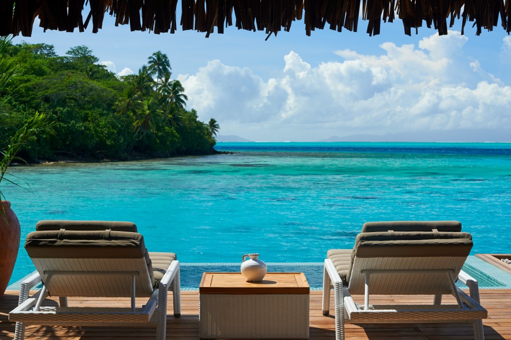 Royal Pool Overwater Villa Terrace, lounge chairs overlooking the ocean