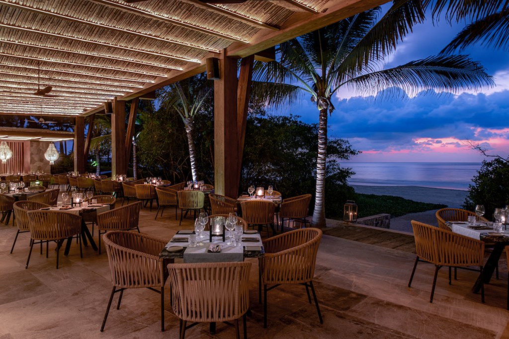 Conrad Punta de Mita - Codex, patio dining area with tables and chairs looking out over the beach