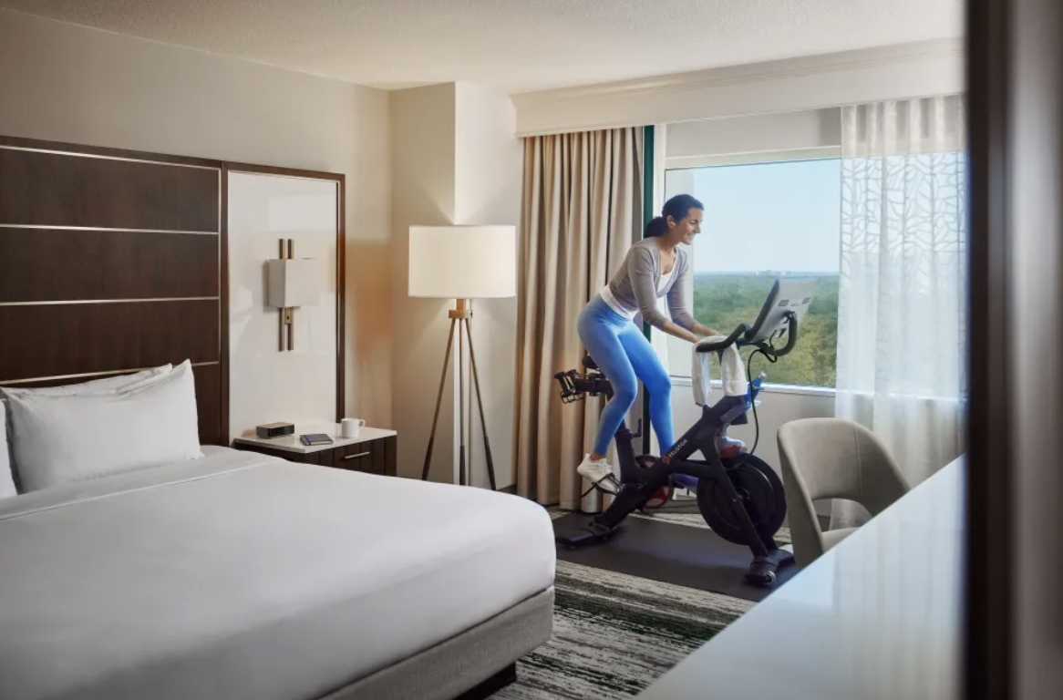 Woman, Peloton Bike, Hilton