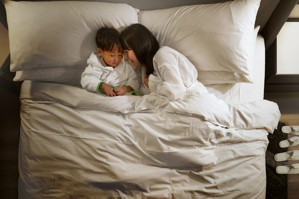 Hilton Singapore Orchard, woman and child, white robe, white bedding, white slippers