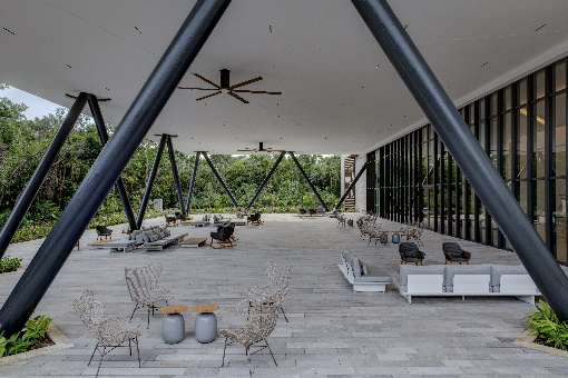 Tulkal Event Center at Hilton Tulum Riviera Maya All-Inclusive Resort, outdoor seating, lounge area, grey coffee table, grey couch cushions, black rocking chairs, black support beams, ceiling fan