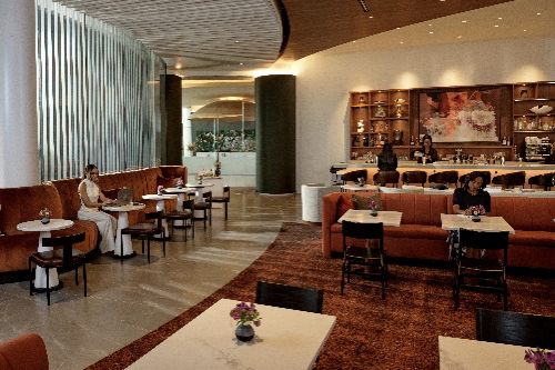 Club Signia at Signia by Hilton Atlanta, dining area, teracotta lounge furniture, bar, marble tables, black dining chairs