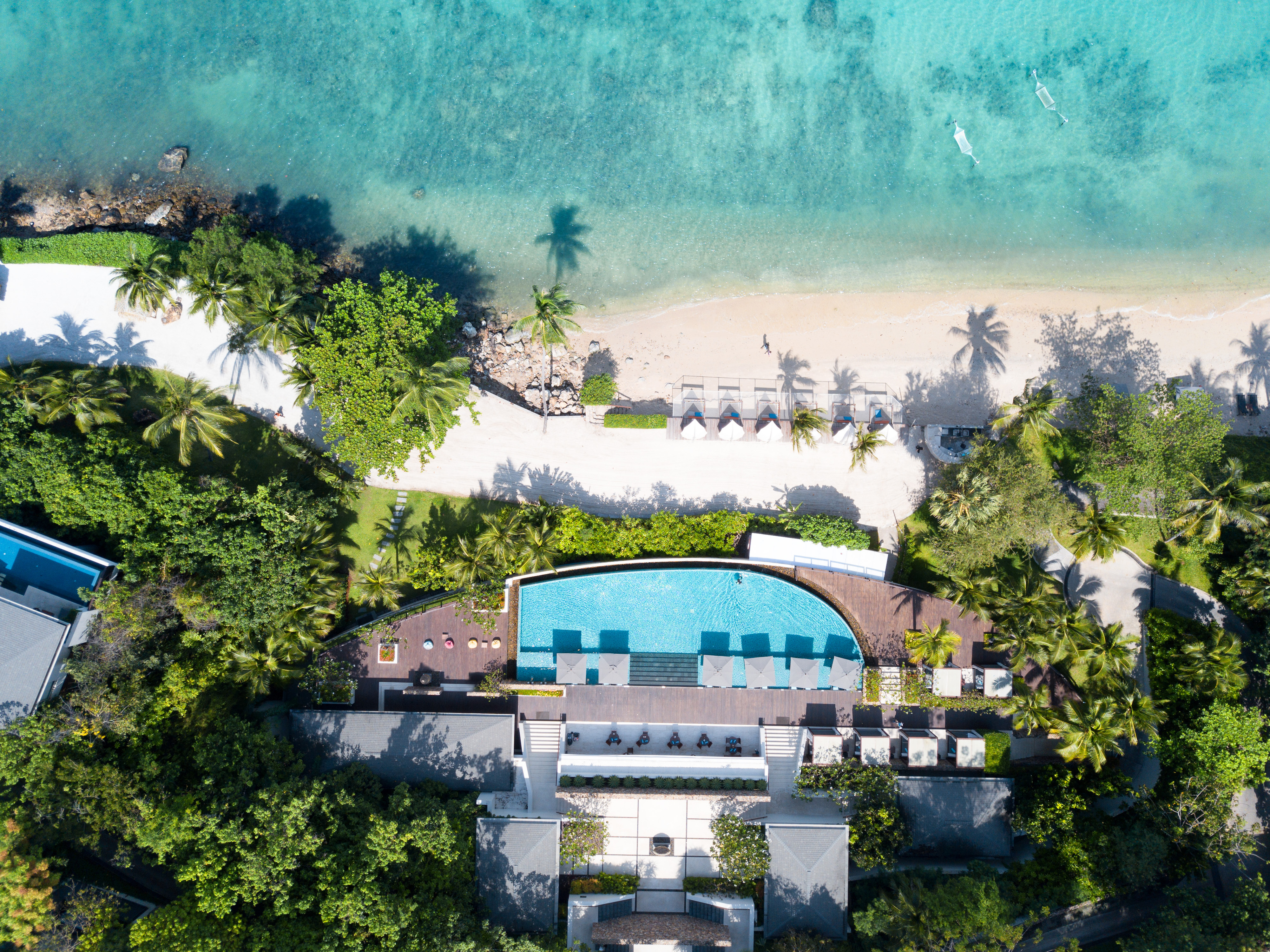 Conrad Koh Samui, Pool, aerial view, beach, grey umbrellas, palm trees, water hammocks, white sand