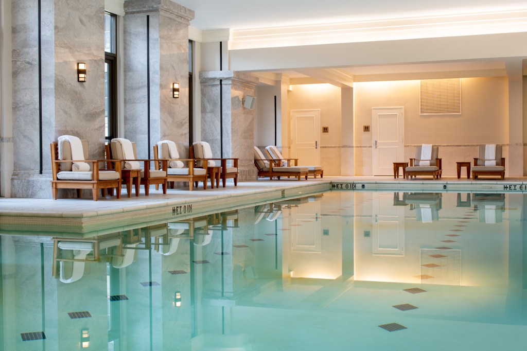 Waldorf Astoria Atlanta Buckhead, Indoor Pool, lounge sitting area, chaise seats, marble wall columns, sconce light fixtures