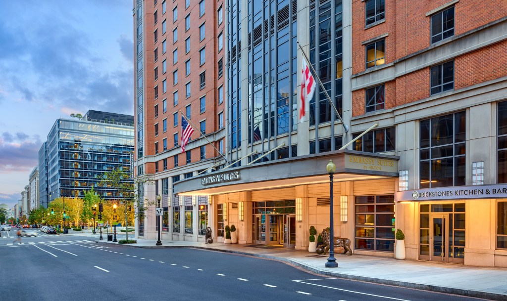 Embassy Suites Washington DC Convention Center, Exterior, main entrance, American flag, statue, potted plants, sidewalk, valet pull off, light post