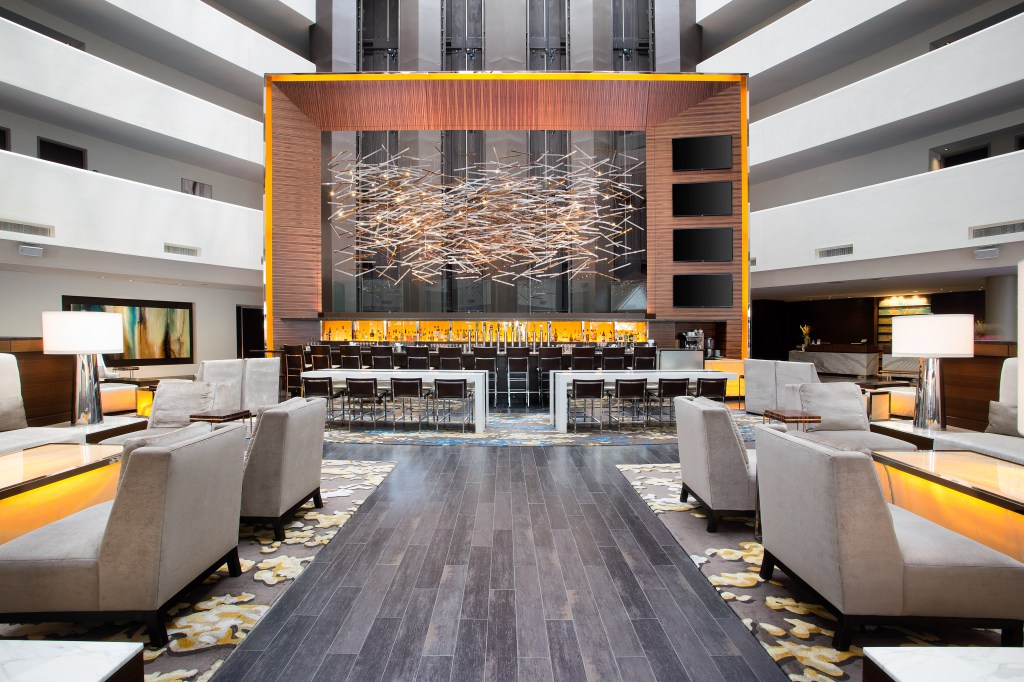 Hilton McLean Tysons Corner, Lobby, Bar, hanging artwork, sitting area, table lamp, walkway