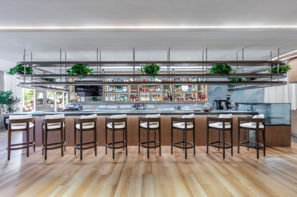 Beach House Fort Lauderdale, a Hilton Resort - Barto Bar, bar area with bar chair and bottles and glasses behind bar