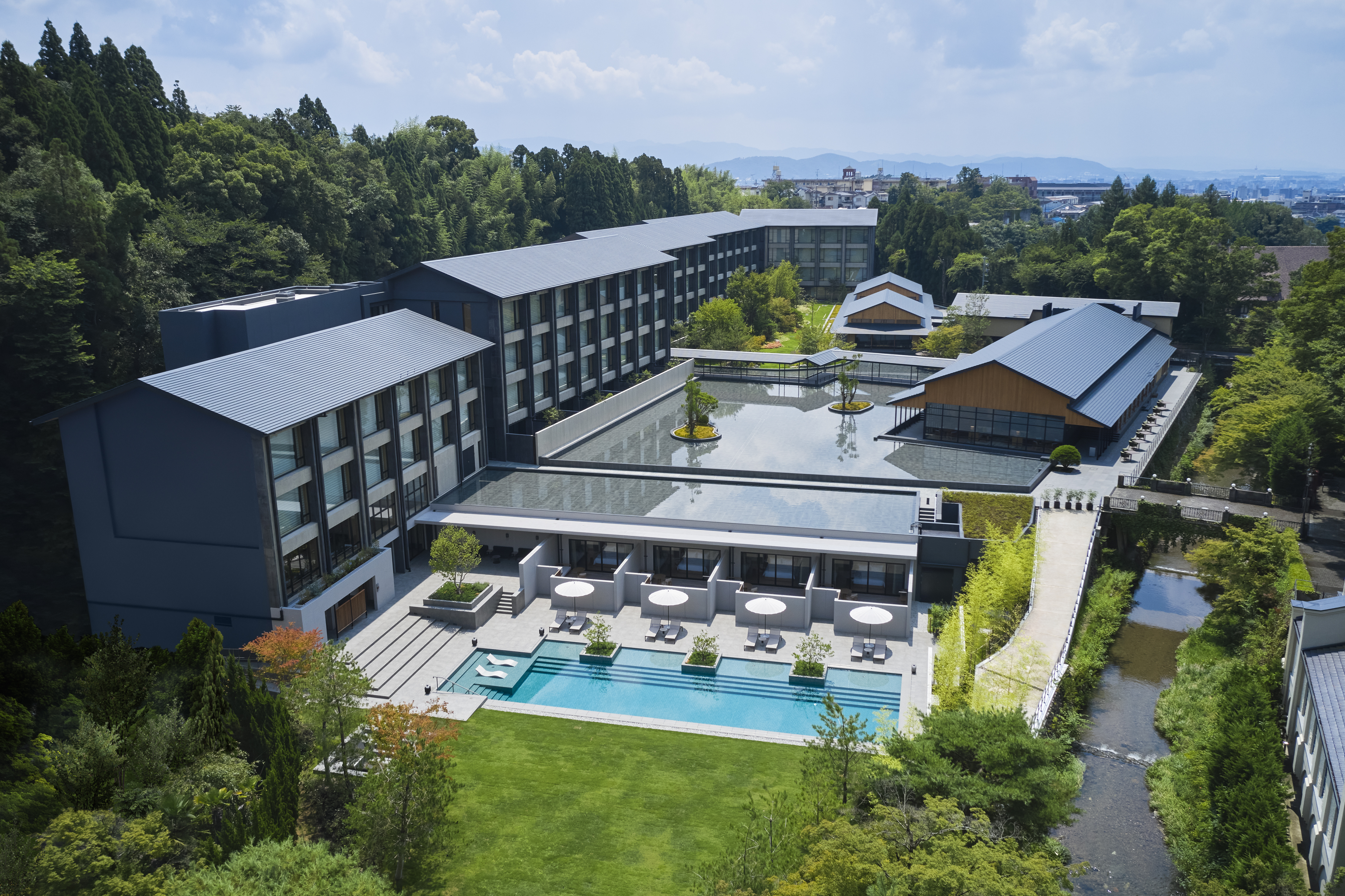 ROKU KYOTO, LXR Hotels &amp; Resorts, Exterior Day, aerial view of white umbrellas and lounge chairs near the pool, rooftop garden