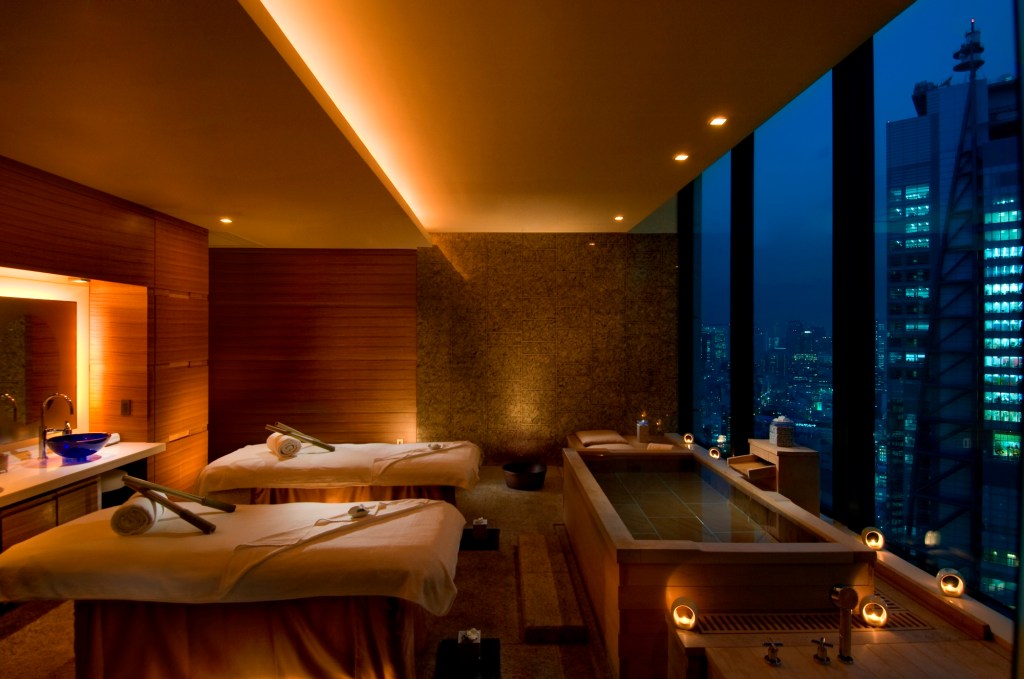 Conrad Tokyo, Mizuki Spa Mizuki Room with two massage beds and a soaking bath windows overlooking the city