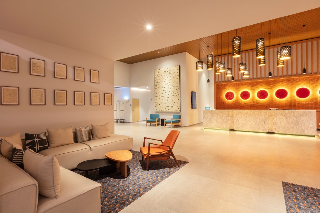Hilton Garden Inn Guadalajara Airport lobby with lounge seating area and reception desk