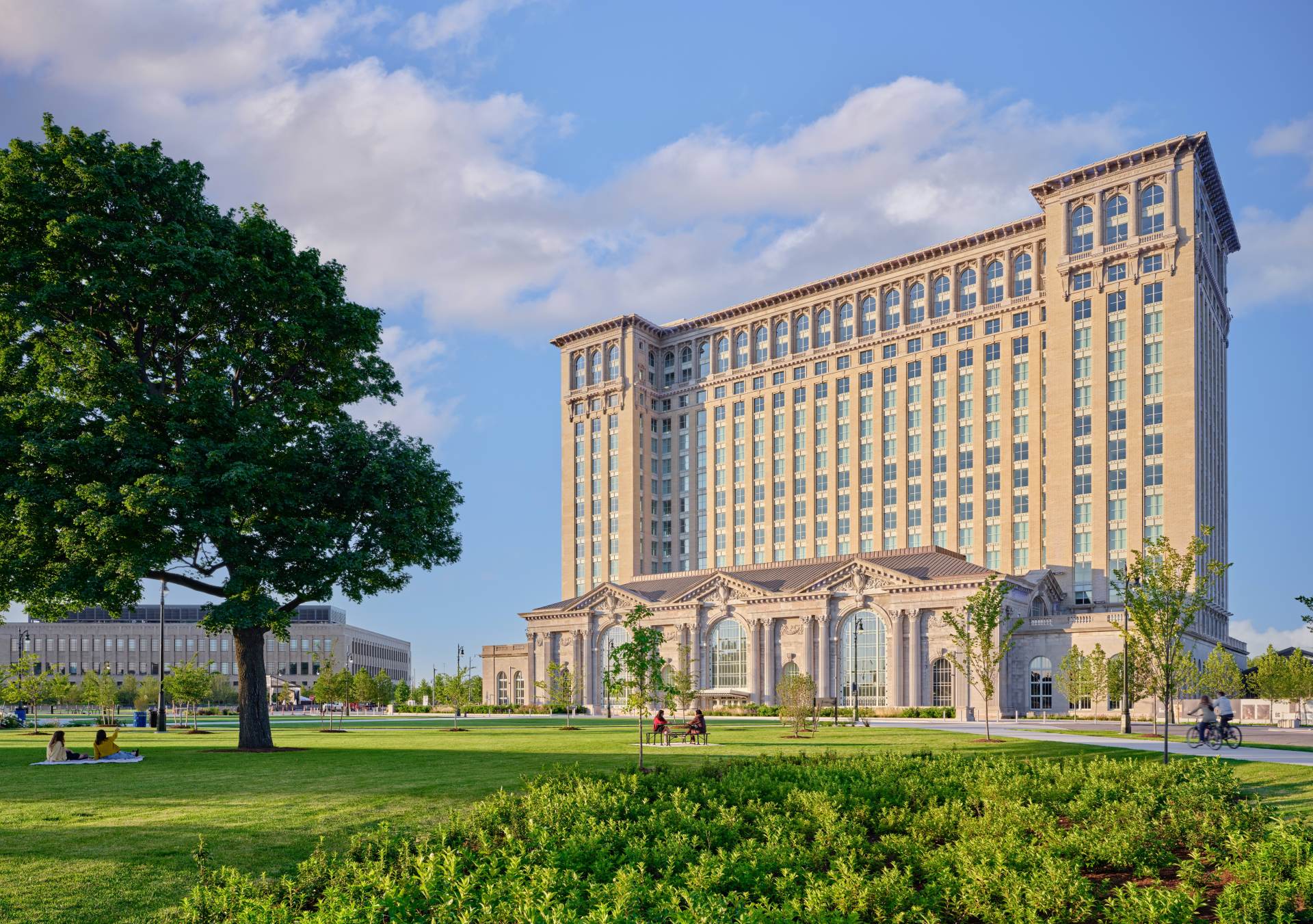 The Station at Michigan Central wide photo with grass, trees, The Station - Credit Jason Keen