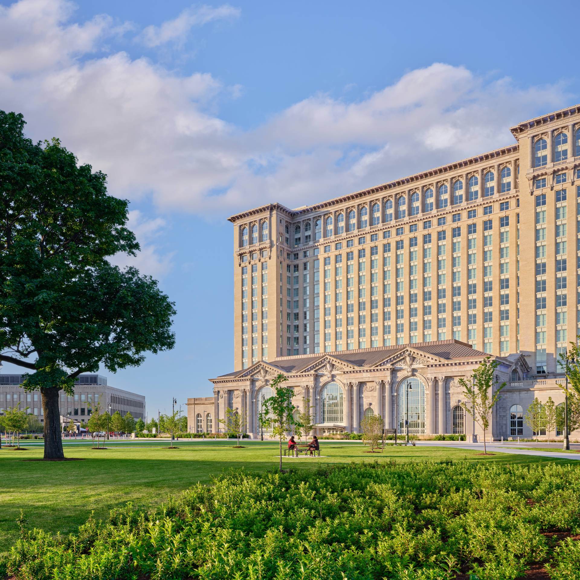 The Station at Michigan Central wide photo with grass, trees, The Station - Credit Jason Keen