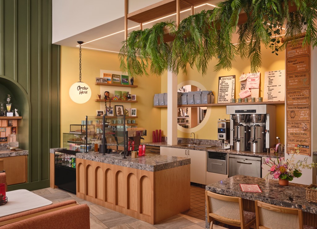The Ambassador Hotel of Waikiki, Tapestry Collection by Hilton - Favorite Son Cafe - Credit - Michael Clifford, caffe area with counter and case for drinks and pastries, behind the counter there is a sink, coffee maker and other commercial drink makers/dispensers