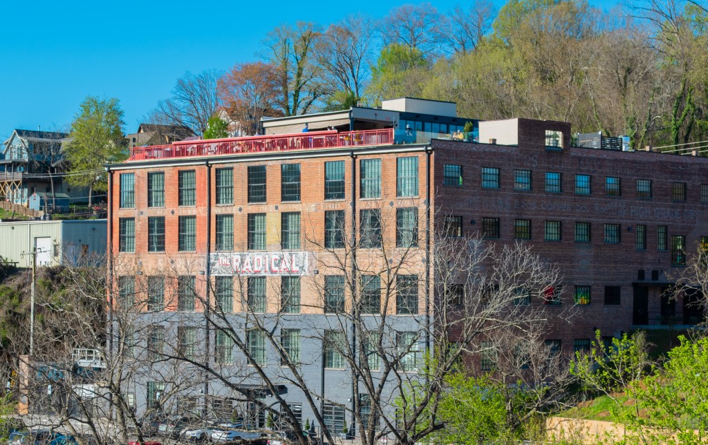 The Radical sign on front of brick building