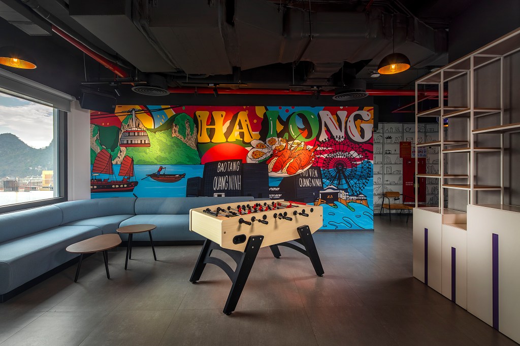 Tru By Hilton Ha Long Hon Gai Centre Mural, foosball table, mural wall art, blue couch with coffee tables