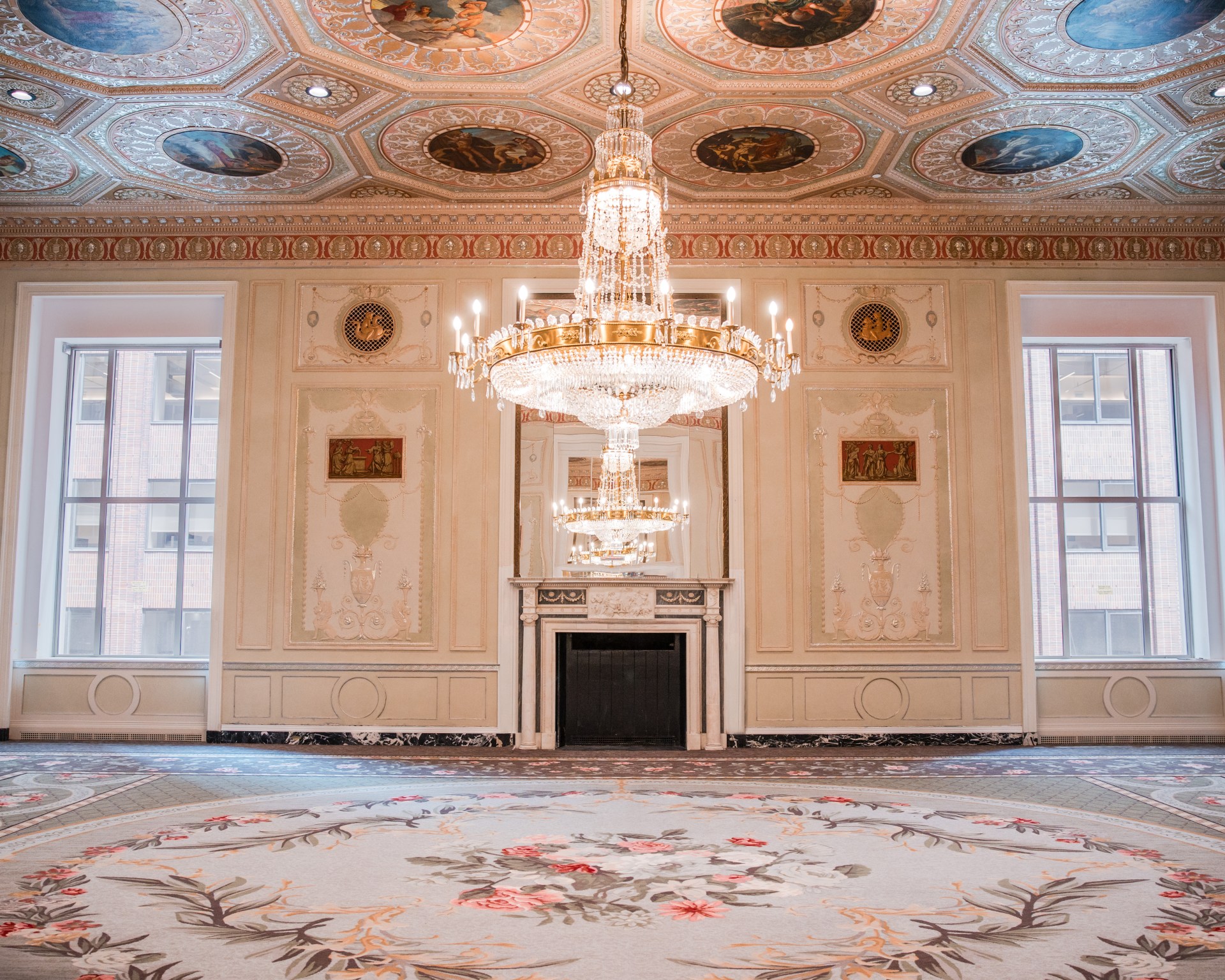 Waldorf Astoria New York Basildon Fireplace - Credit Waldorf Astoria New York, large carpeted room with chandelier and fireplace