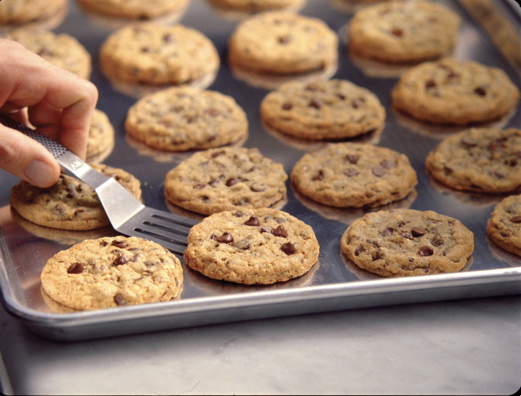 Tray of freshly baked chocolate chip cookies being served, a signature warm welcome treat at DoubleTree by Hilton.