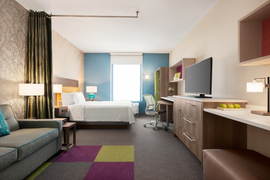 Home2 Suites By Hilton Overland Park, KS - Guest Room with bed, sofa, desk, chair, television, closet