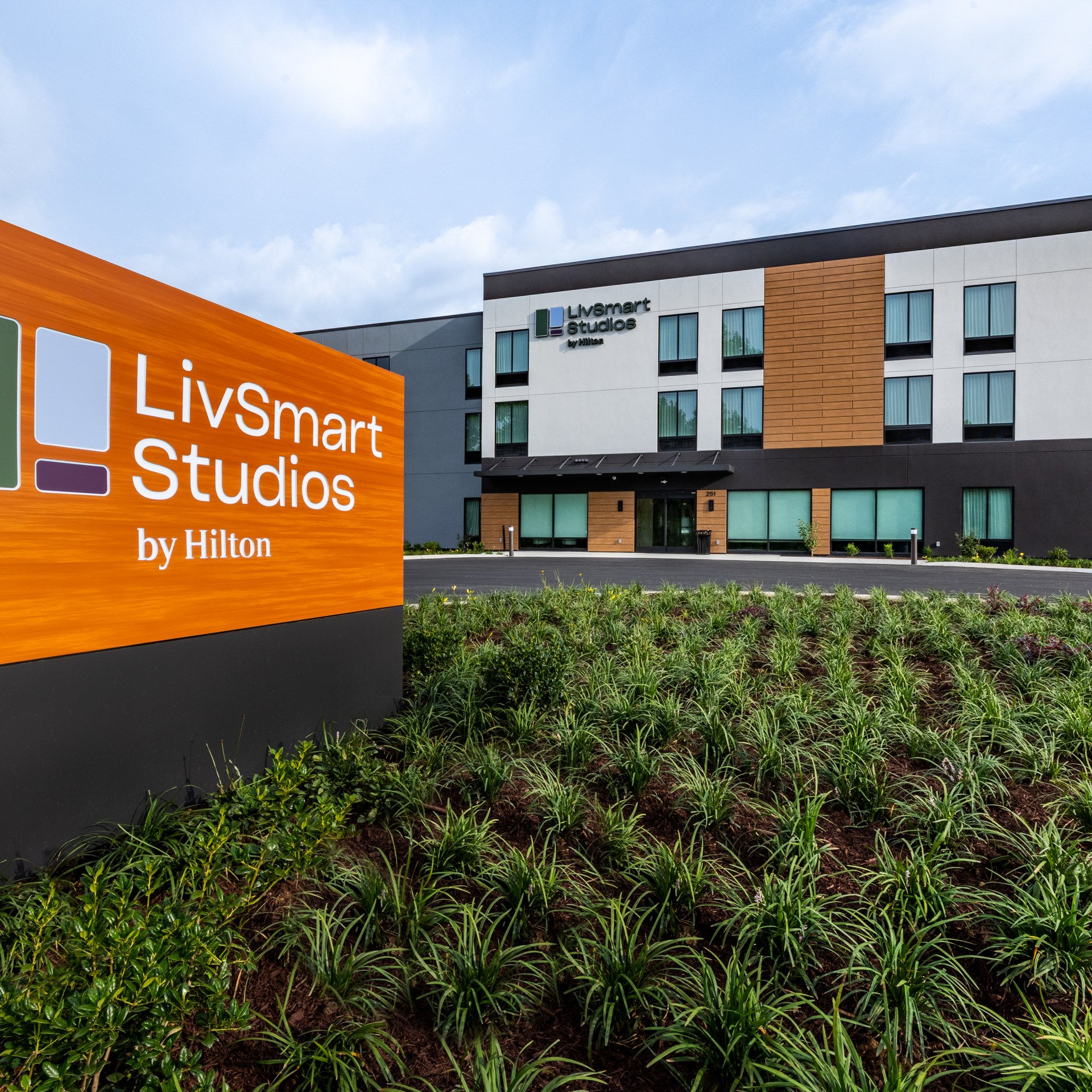 LivSmart Studios by Hilton Tullahoma - Exterior of hotel and wood LivSmart Studios by Hilton sign in foreground