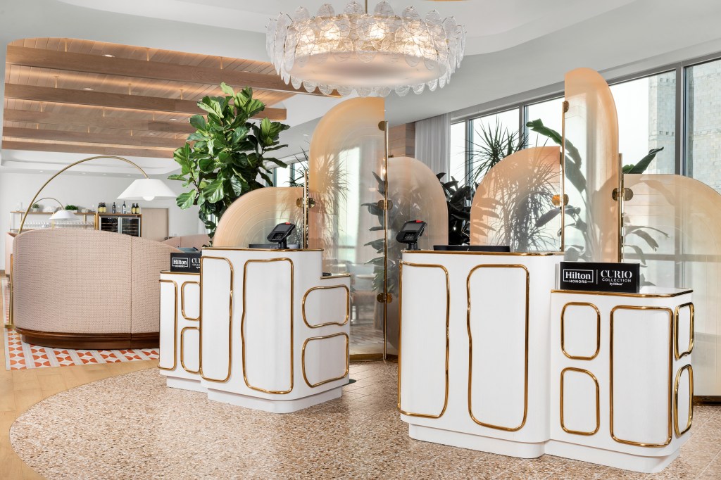 The Hiatus Clearwater Beach, Curio Collection by Hilton - lobby area with white and gold check in desks, plants and large lighting fixture