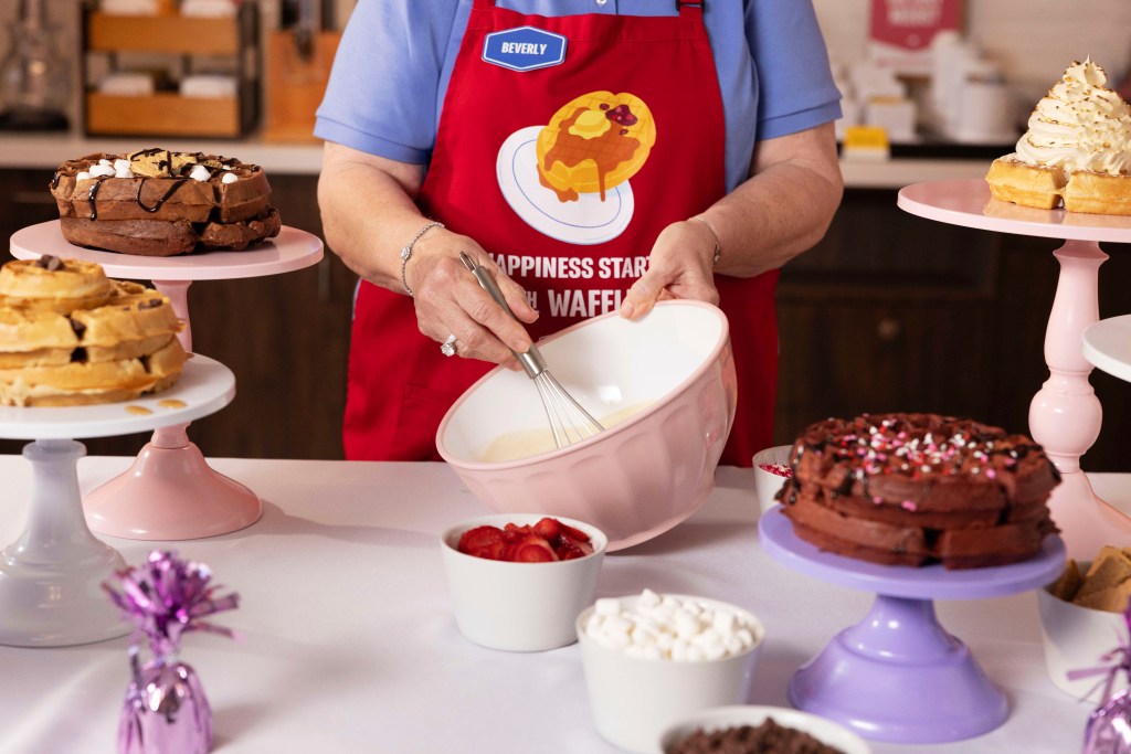 Hampton by Hilton Waffle Boss Beverly Christmas mixes up waffle batter