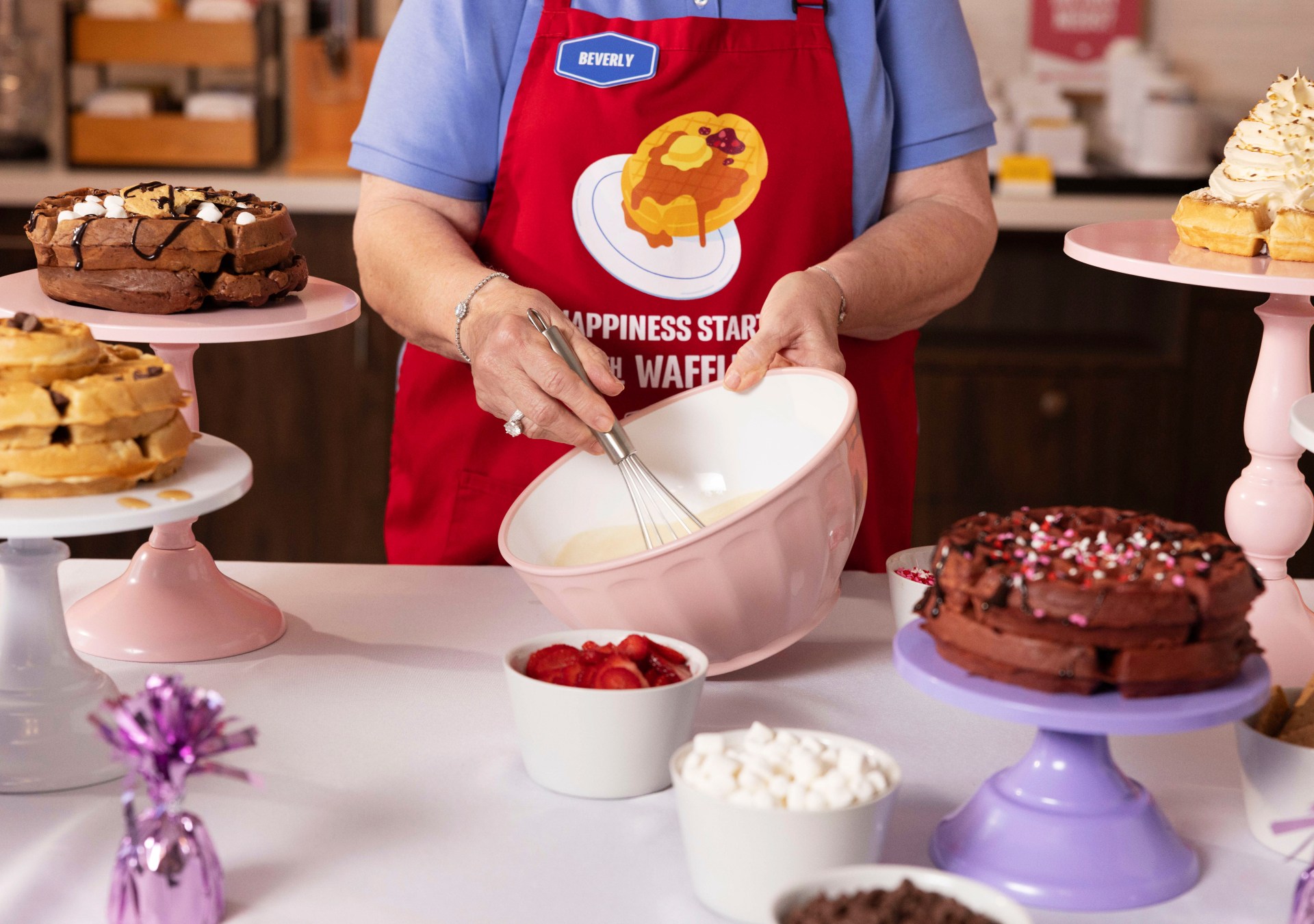 Hampton by Hilton Waffle Boss Beverly Christmas mixes up waffle batter