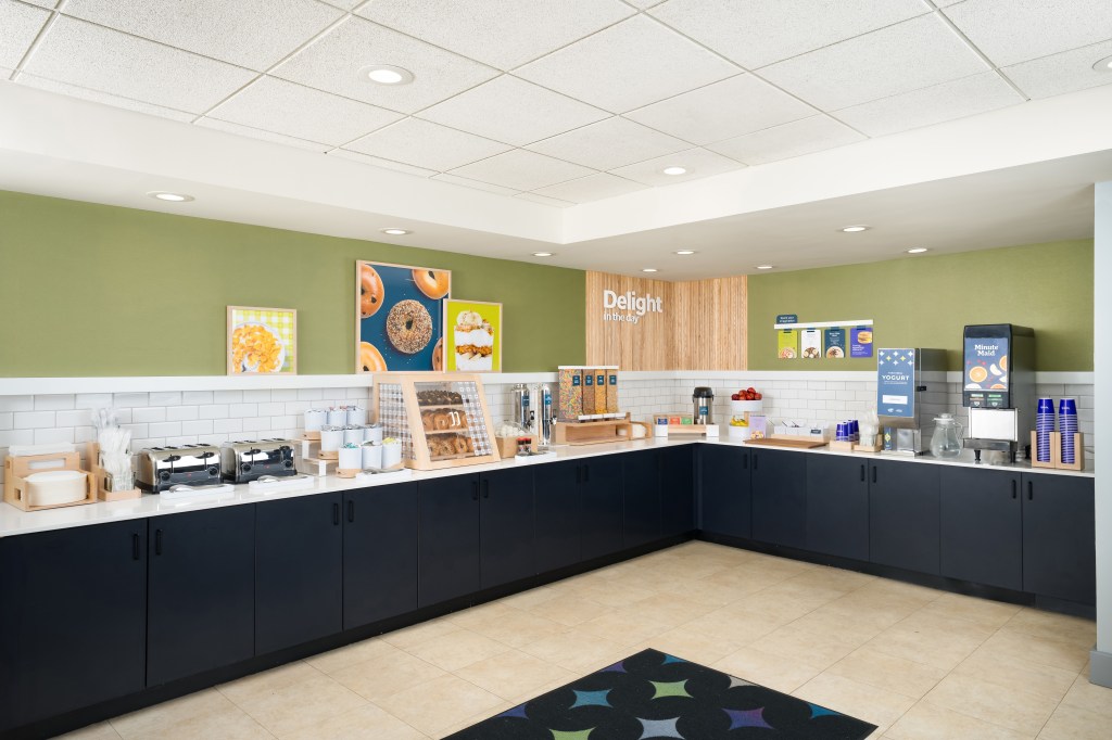 Spark by Hilton - Breakfast Area, with various stations toasters, cereal, bagels, yogurt and juices
