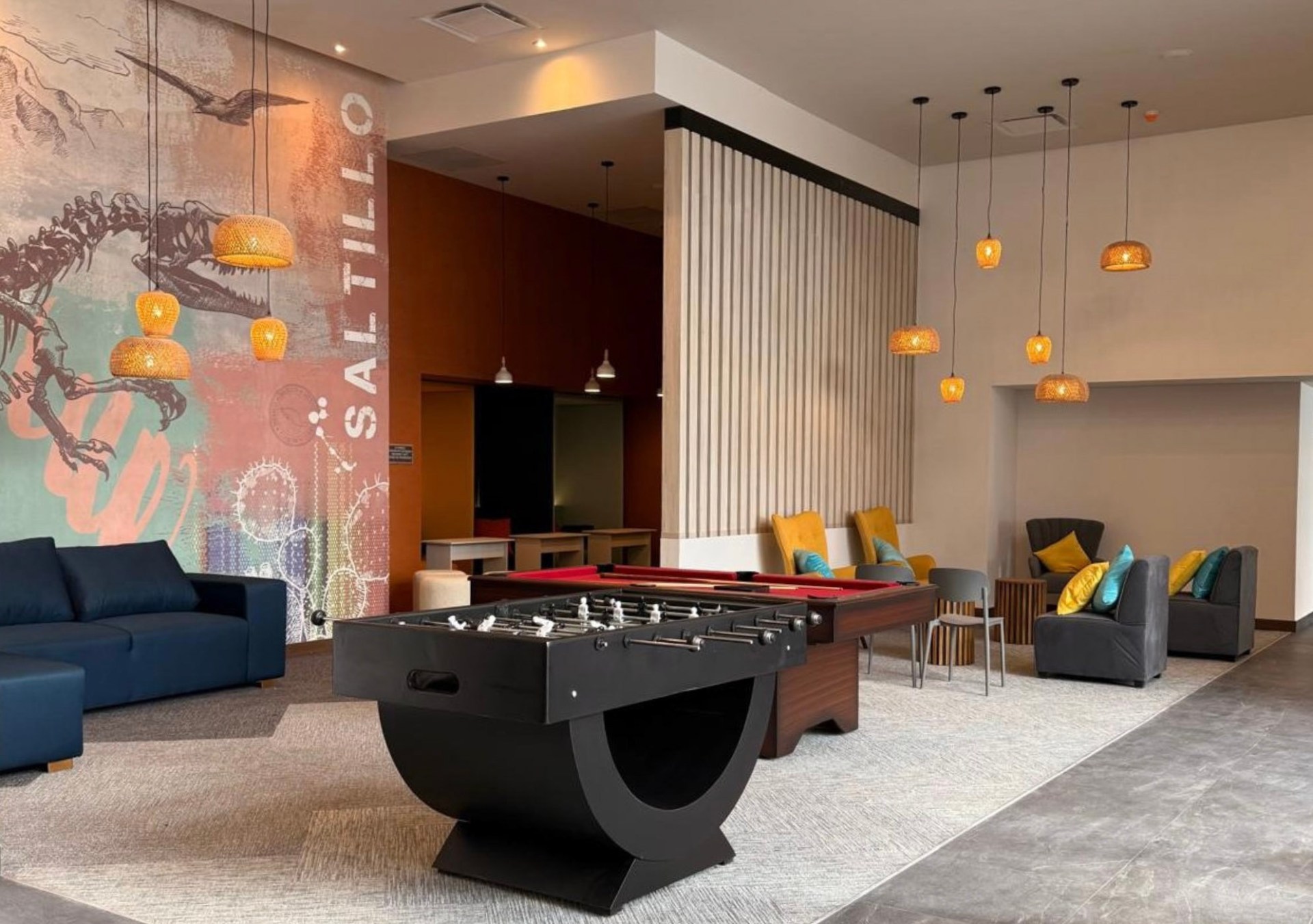 Lobby with sofas, foosball table, and colorful mural