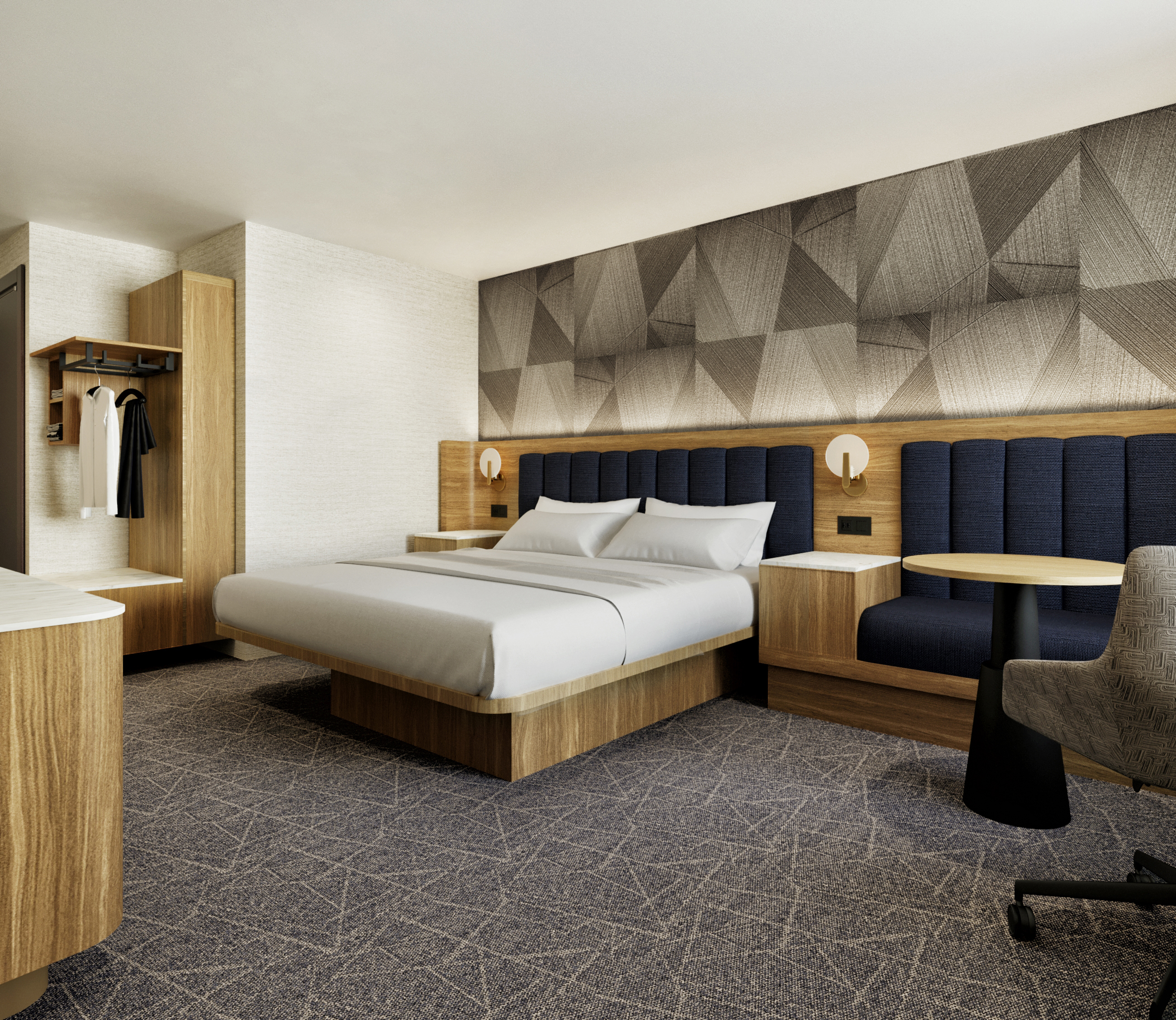 A bedroom with bed, seating area, and space to hang clothes