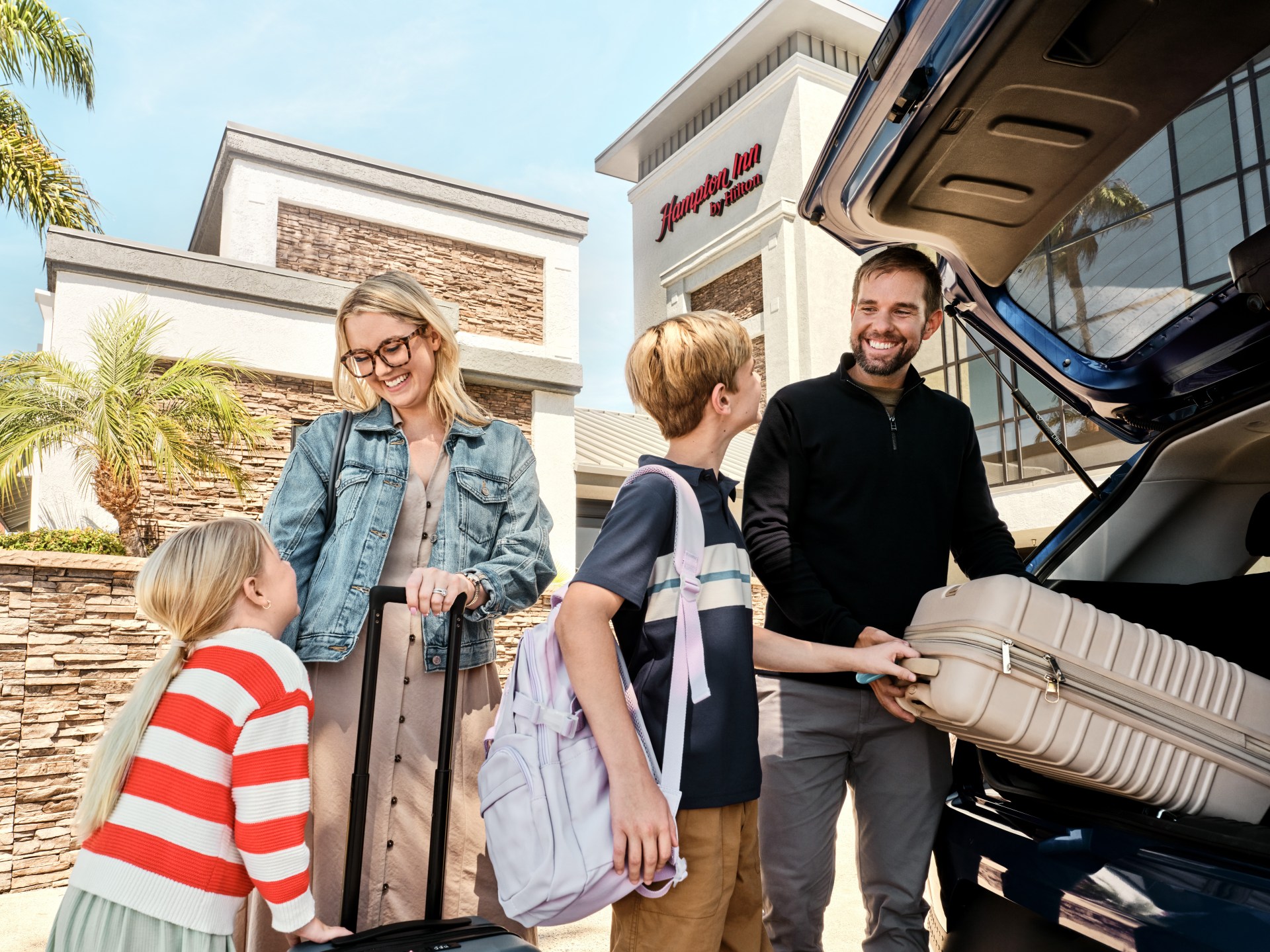 Hampton Inn by Hilton Costa Mesa Newport Beach, family unloading car outside hotel