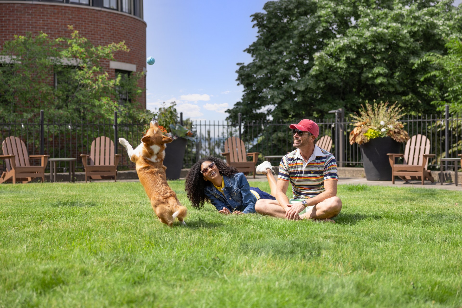 Hotel Champlain, Curio Collection by Hilton, family sitting on lawn playing with dog
