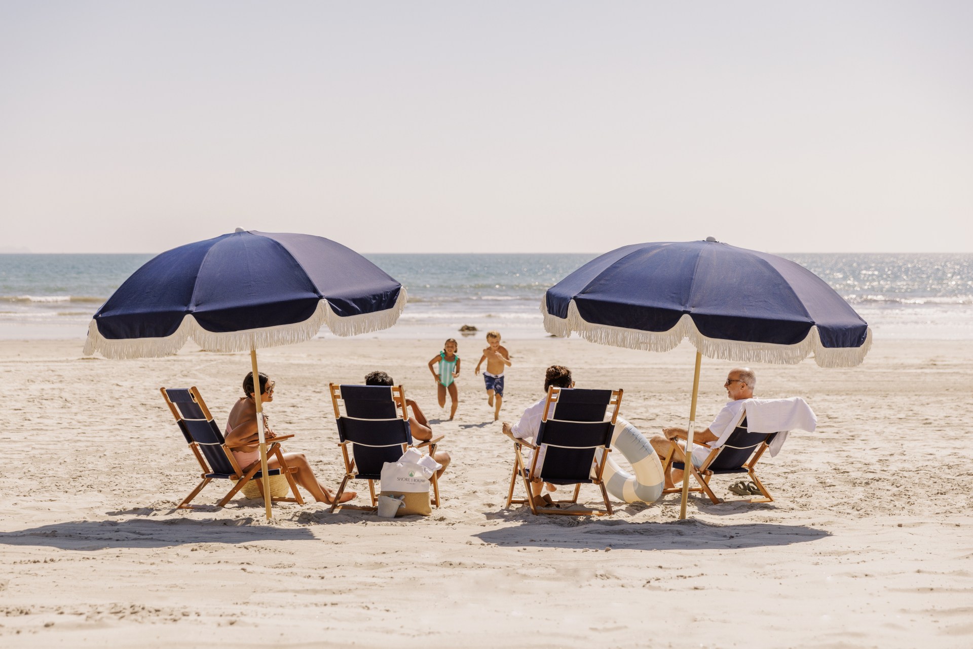 Shore House at The Del, LXR Hotels & Resorts, family playing and loungin on the beach