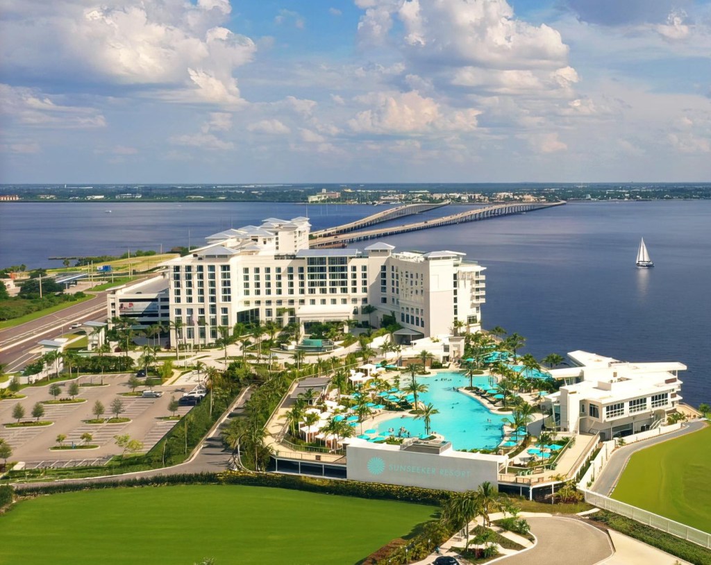 An overlook of the whole exterior of the Sunseeker Resort, with a large pool and the ocean in the background.