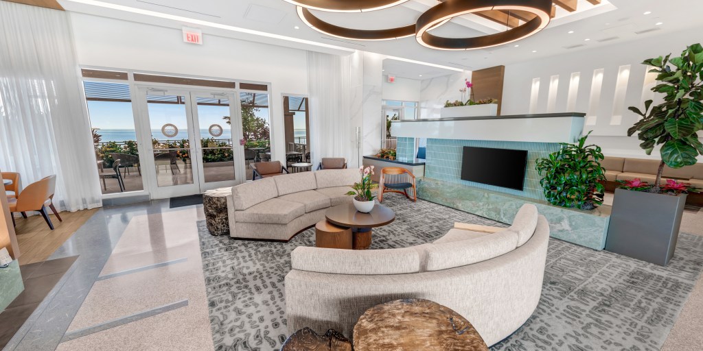 The lobby of the Sunseeker Resort, featuring a conversation area with two couches and a patio in the background
