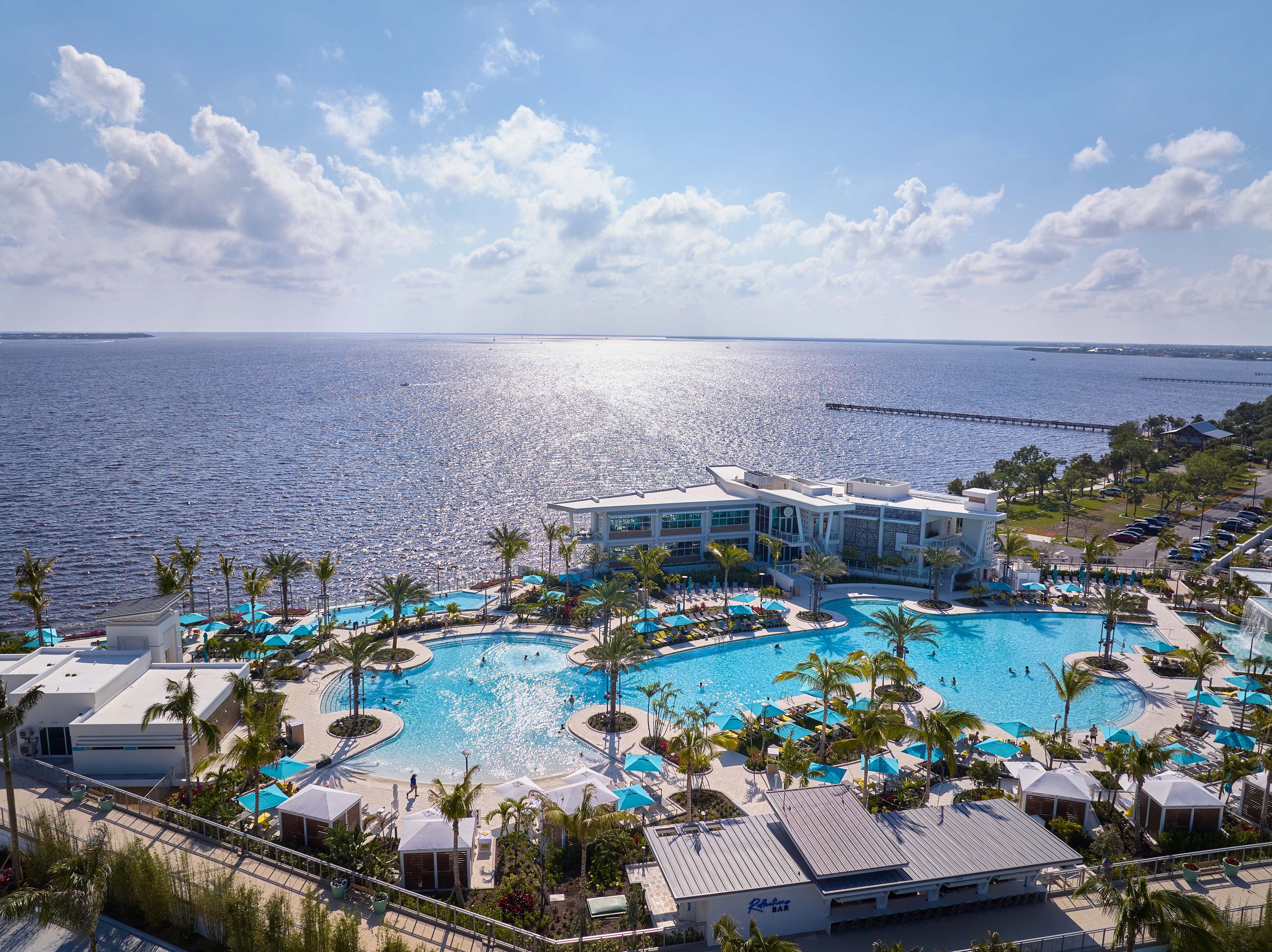 A view from over the pool, with a view of the ocean in the background.