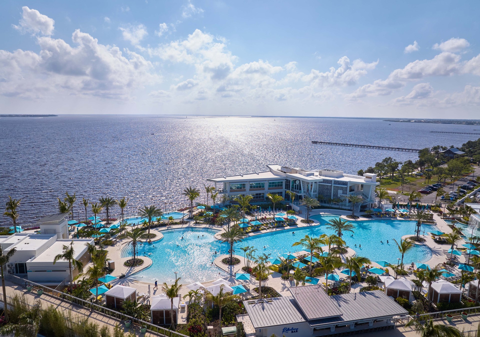 A view from over the pool, with a view of the ocean in the background.