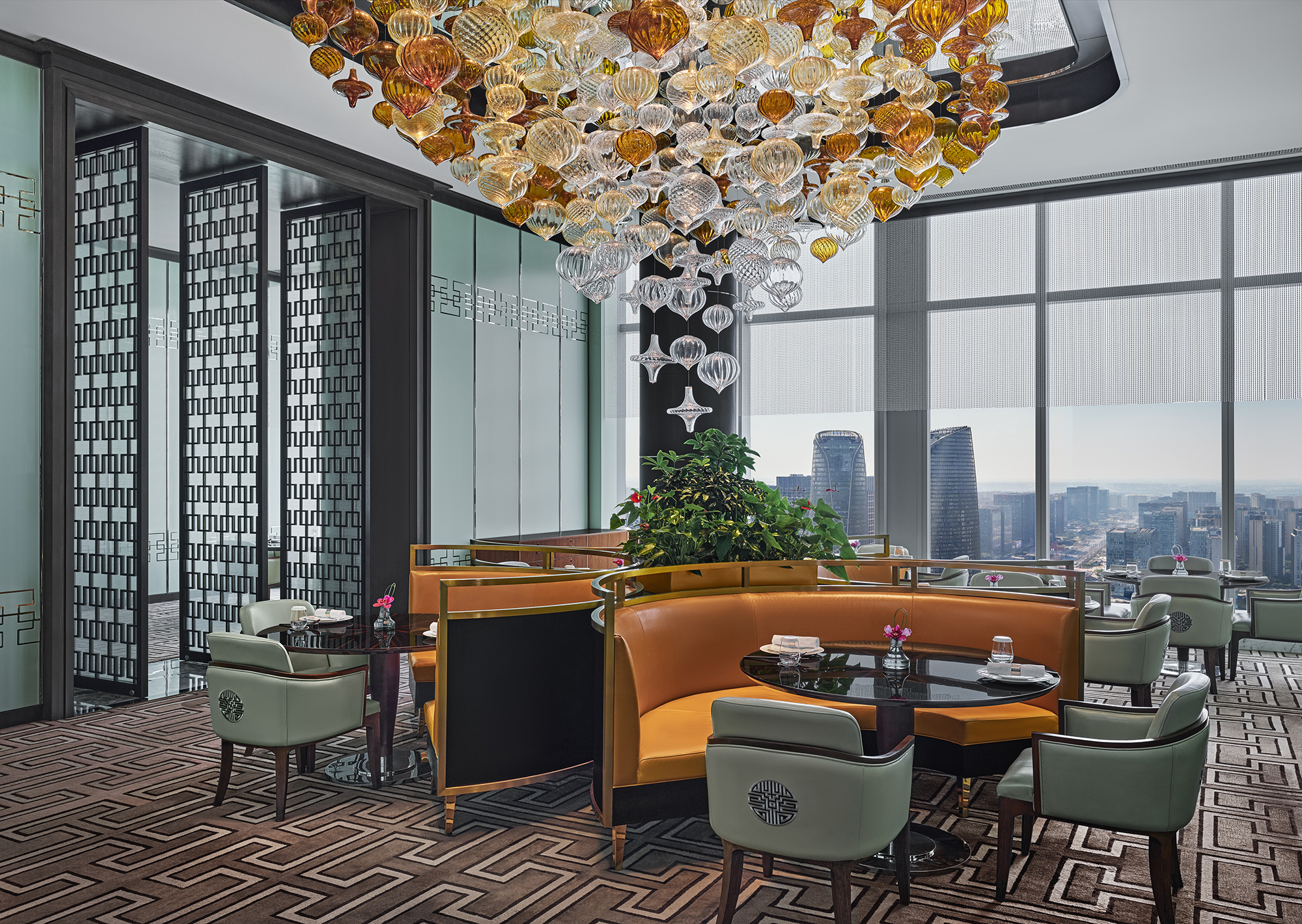 Waldorf Astoria Chengdu - Infinite Luck 成都华尔道夫酒店运·中餐厅, dining area with colorful bench seating, dining room with colorful blown glass strung from ceiling, dining room with view of city