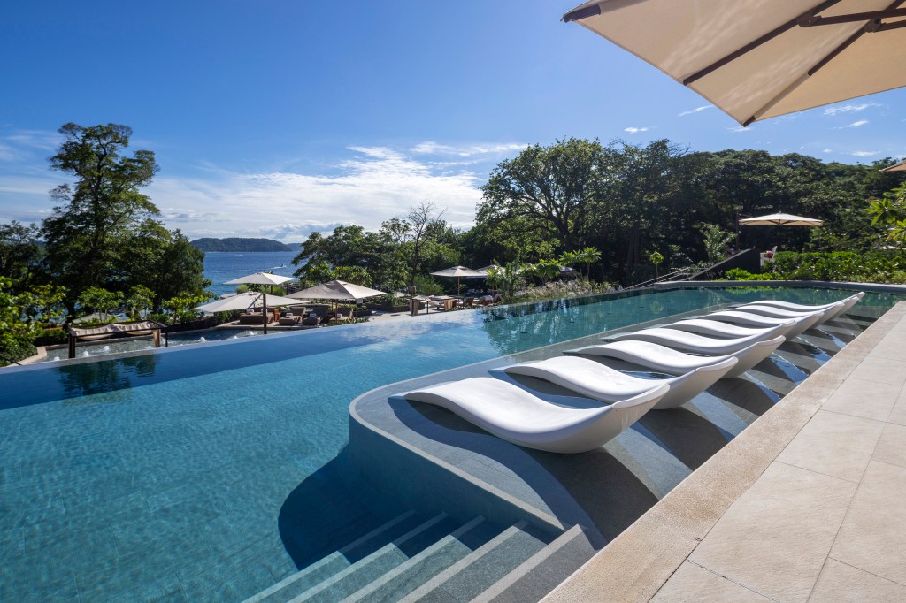 Waldorf Astoria Costa Rica Punta Cacique - Pool Loungers overlooking pool and ocean
