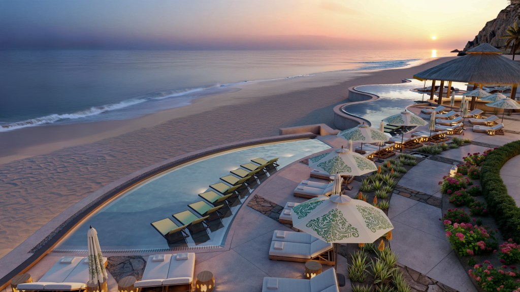 Waldorf Astoria Los Cabos Pedregal Adult Pool with chaise lounge chairs and umbrellas with green design and planted landscape along pathway overlooking beach and waterfront