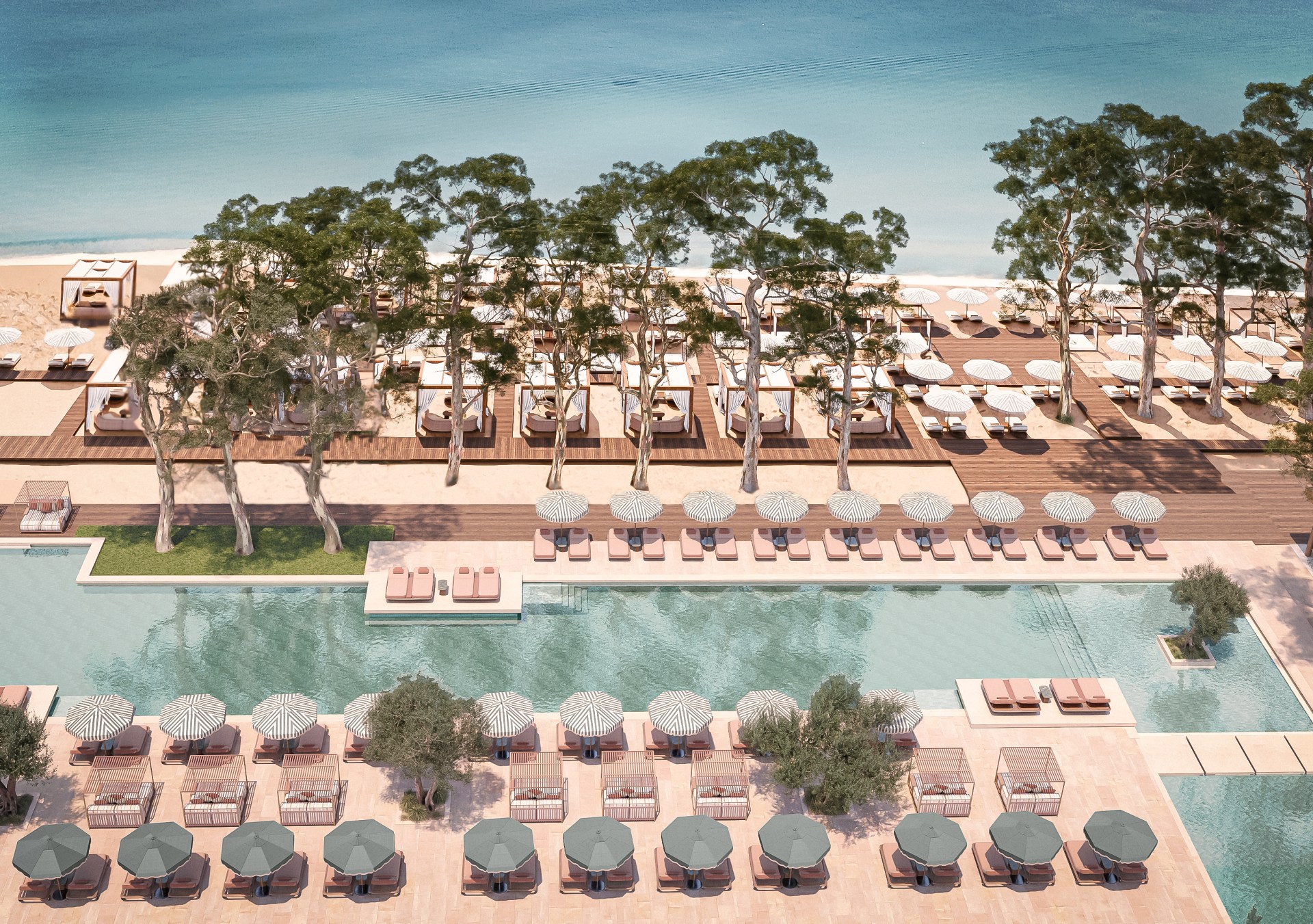 Conrad Corfu - Outdoor Pool - long pool surrounded by lounge chairs and cabanas, leading to beach area with trees, lounge chairs and cabanas