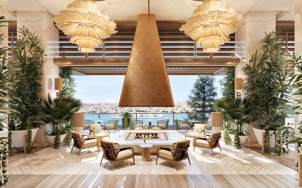 Chairs surrounding a large fire pit overlooking the water.