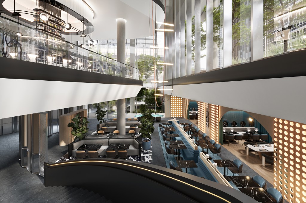 Looking down on a restaurant filled with tables, chairs, and booth seating, with a second level above