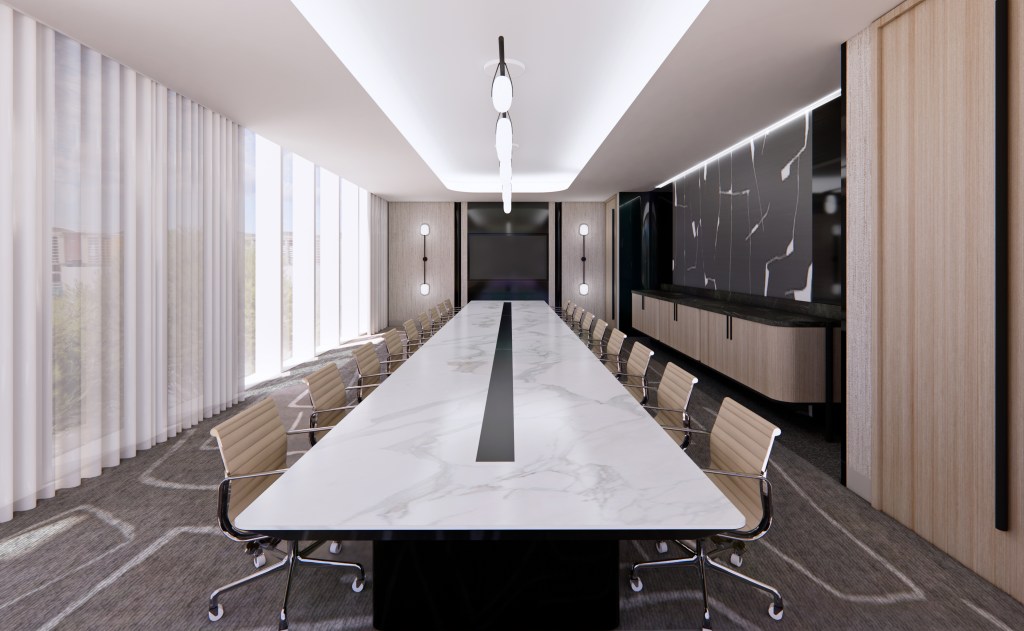 A meeting room with chairs around a long rectangular table