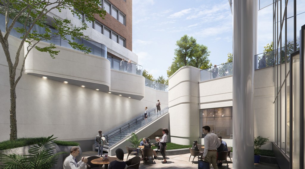 A courtyard with tables and chairs, with stairs going up to ground level.