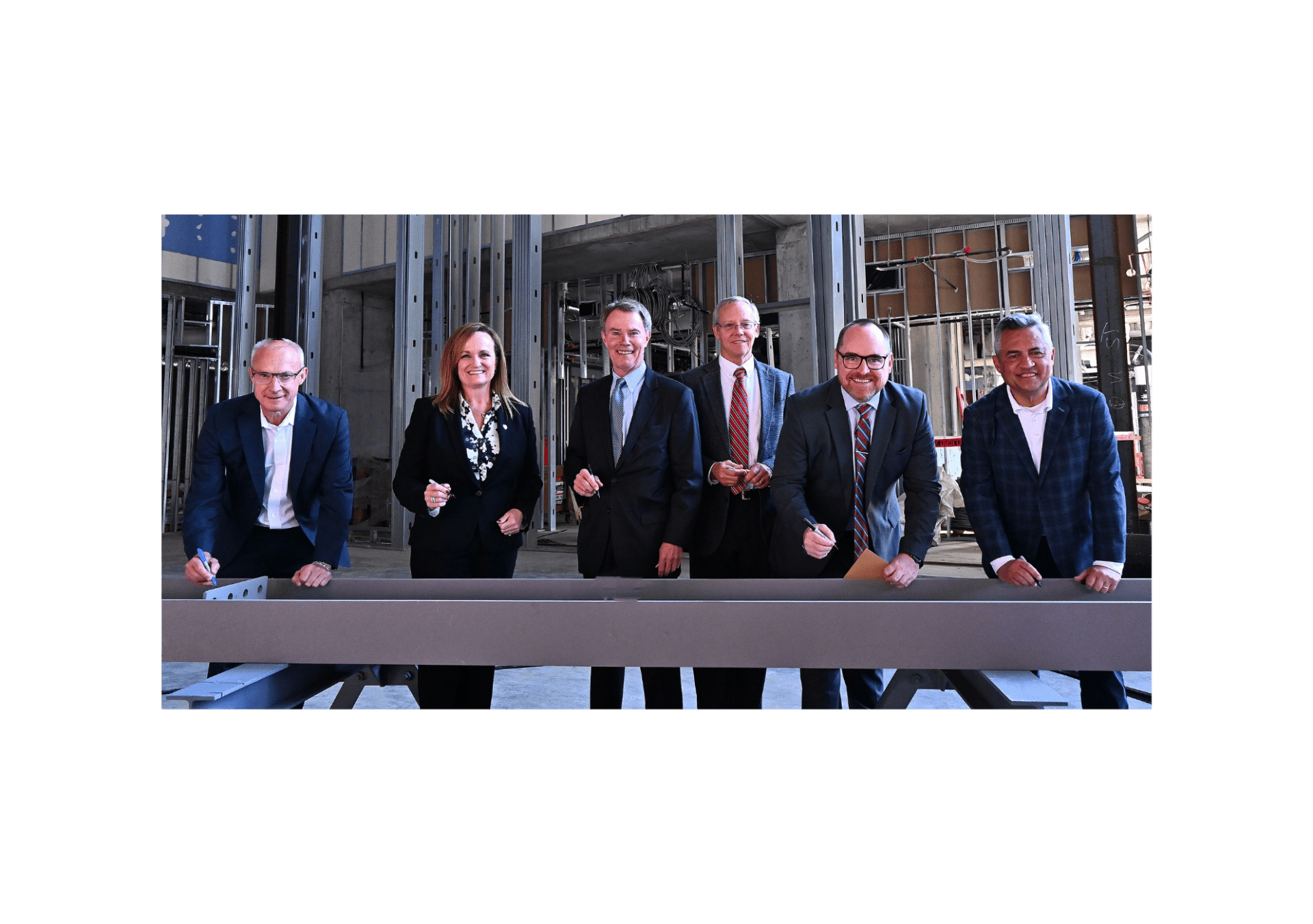 Signia by Hilton Indianapolis topping off ceremony and beam signing - From L-R: Gary Steffen, senior vice president and global category head, Hilton’s Full Service Brands; Kathy Heneghan, general manager, Signia by Hilton Indianapolis; Mayor Joe Hogsett, City of Indianapolis; Bill Sewall, vice president, AECOM; Andy Mallon, executive director, Capital Improvement Board and Leonard Hoops, president & CEO, Visit Indy.