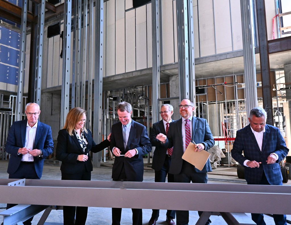 Signia by Hilton Indianapolis beam signing - From L-R: Gary Steffen, senior vice president and global category head, Hilton’s Full Service Brands; Kathy Heneghan, general manager, Signia by Hilton Indianapolis; Mayor Joe Hogsett, City of Indianapolis; Bill Sewall, vice president, AECOM; Andy Mallon, executive director, Capital Improvement Board and Leonard Hoops, president &amp; CEO, Visit Indy.