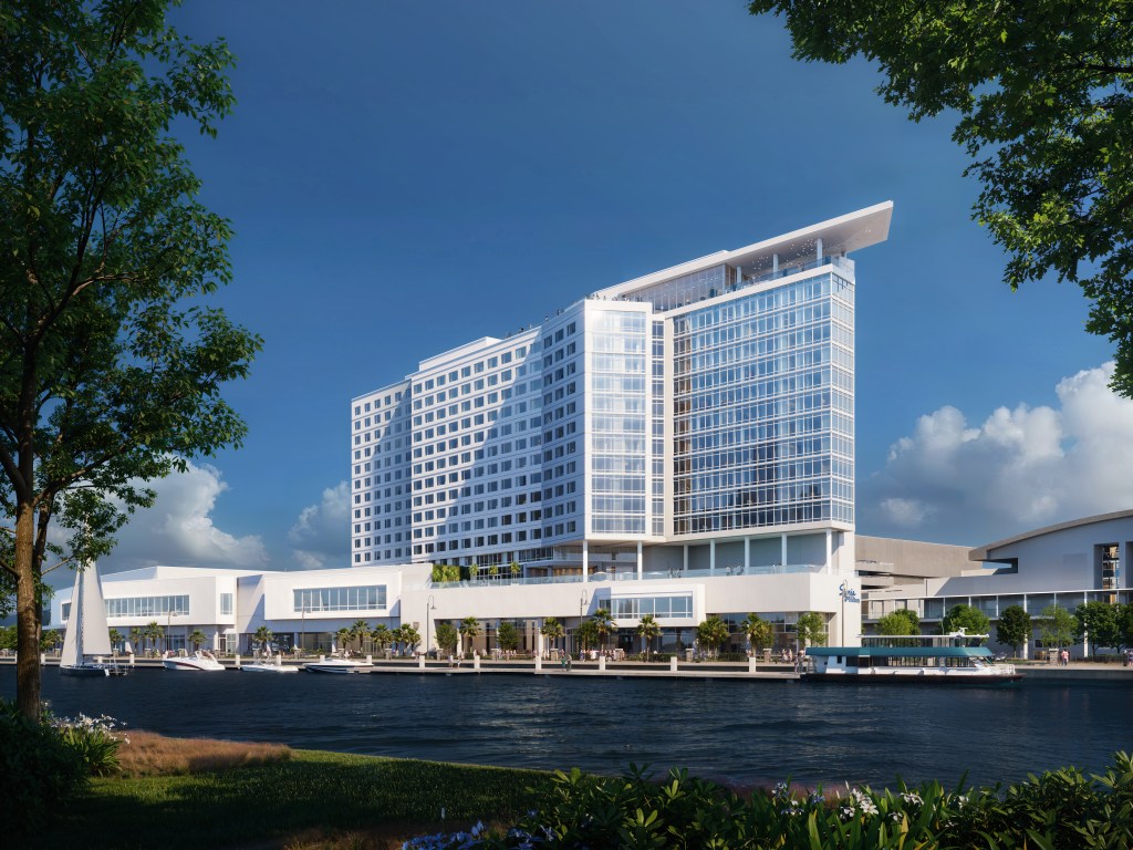 An eye level view of the hotel from across the river